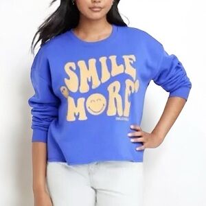 Smiley World “Smile More” Semi- Cropped Crewneck Sweatshirt in Blue + Mustard